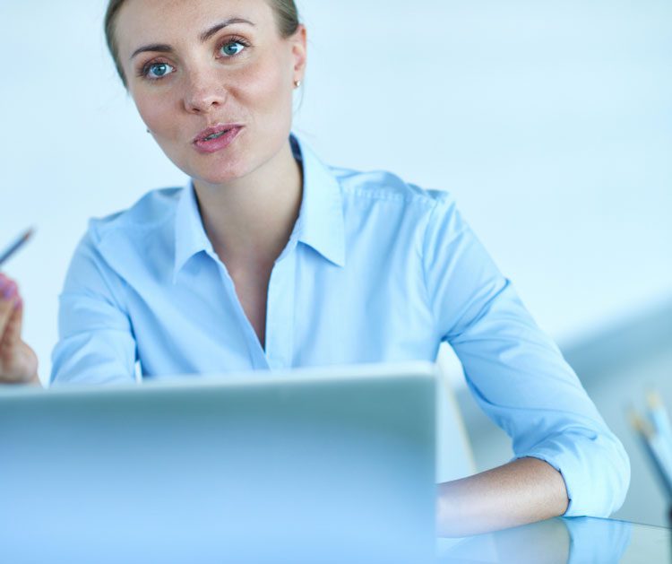 Professional woman talking to someone over a laptop